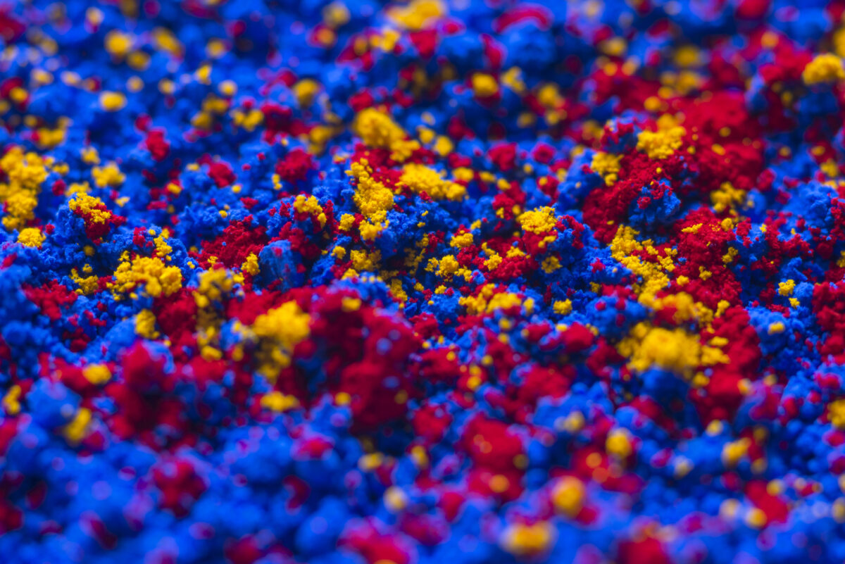 Close-up of red blue yellow pigment powder
