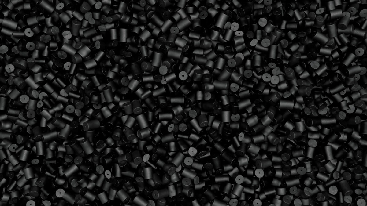 Closeup top view of black plastic polypropylene granules, masterbatch polymer grain. HDPE or PVC resin pellets. 3d render illustration